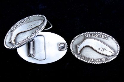 A close up of two silver oval shaped buckles