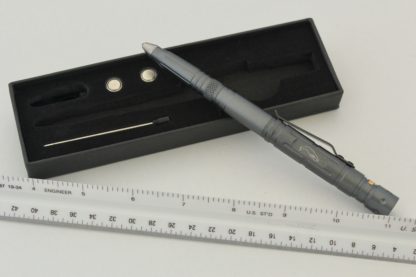 A pen and ruler are next to each other.