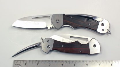 Two knives are shown side by side with a ruler.