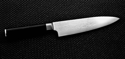 A knife is shown on the black surface.