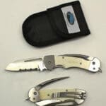 Folding knife set with protective black sheath.
