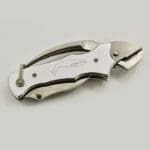 Folding knife with whale engraving on handle.