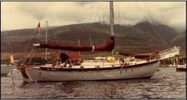 Vintage sailboat with red sail cover
