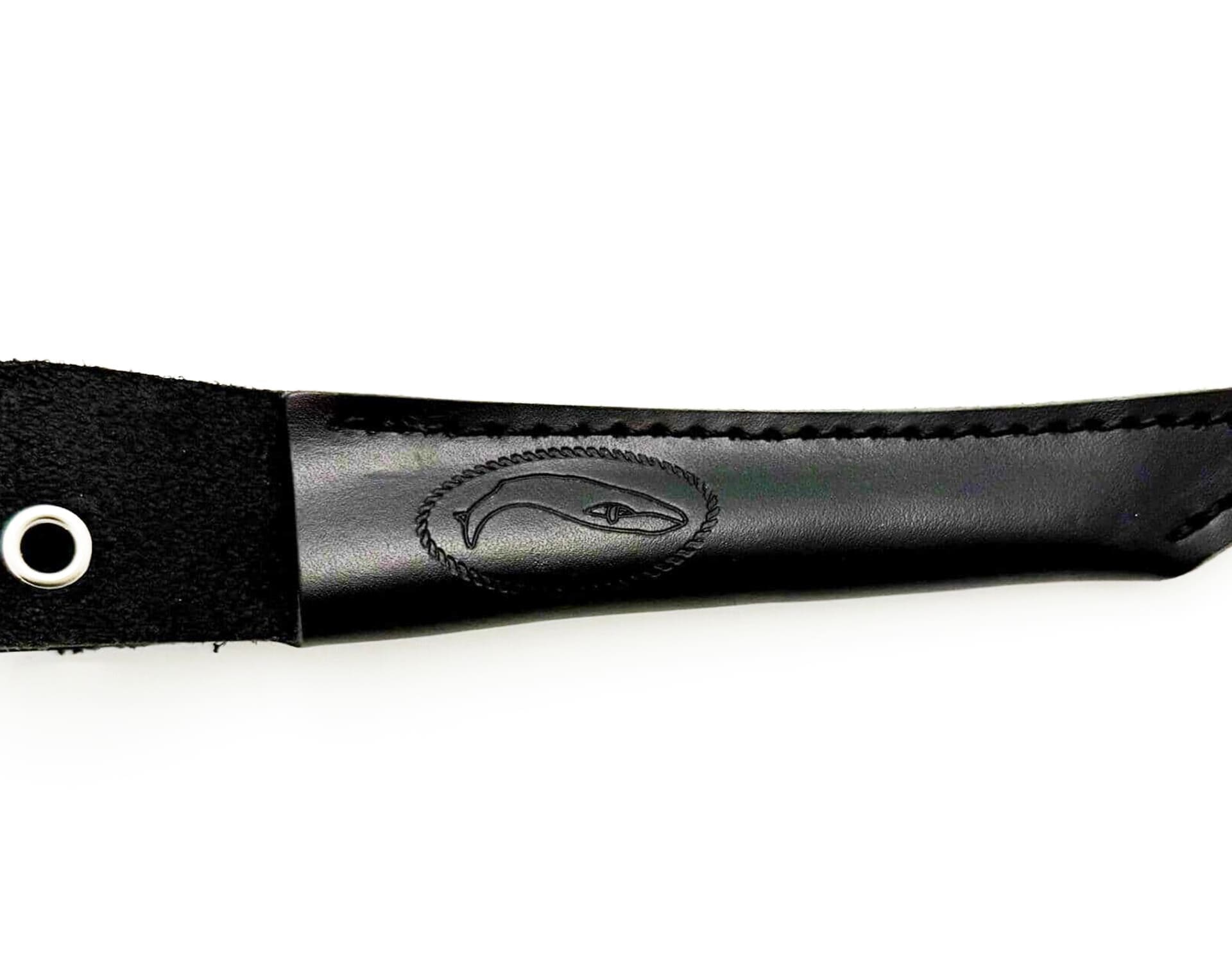 Black leather knife sheath with whale logo.