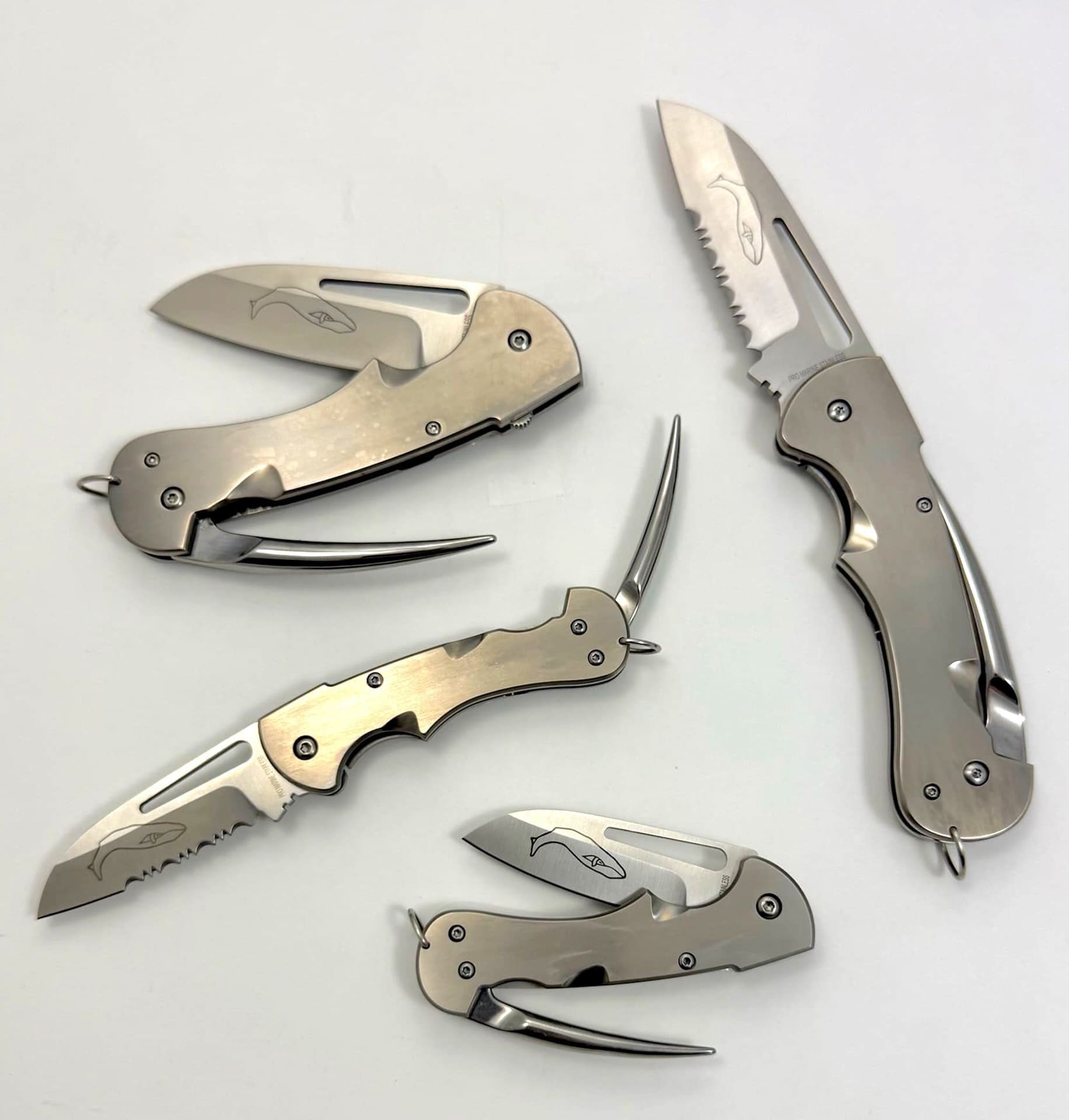 Set of four sleek folding knives displayed.