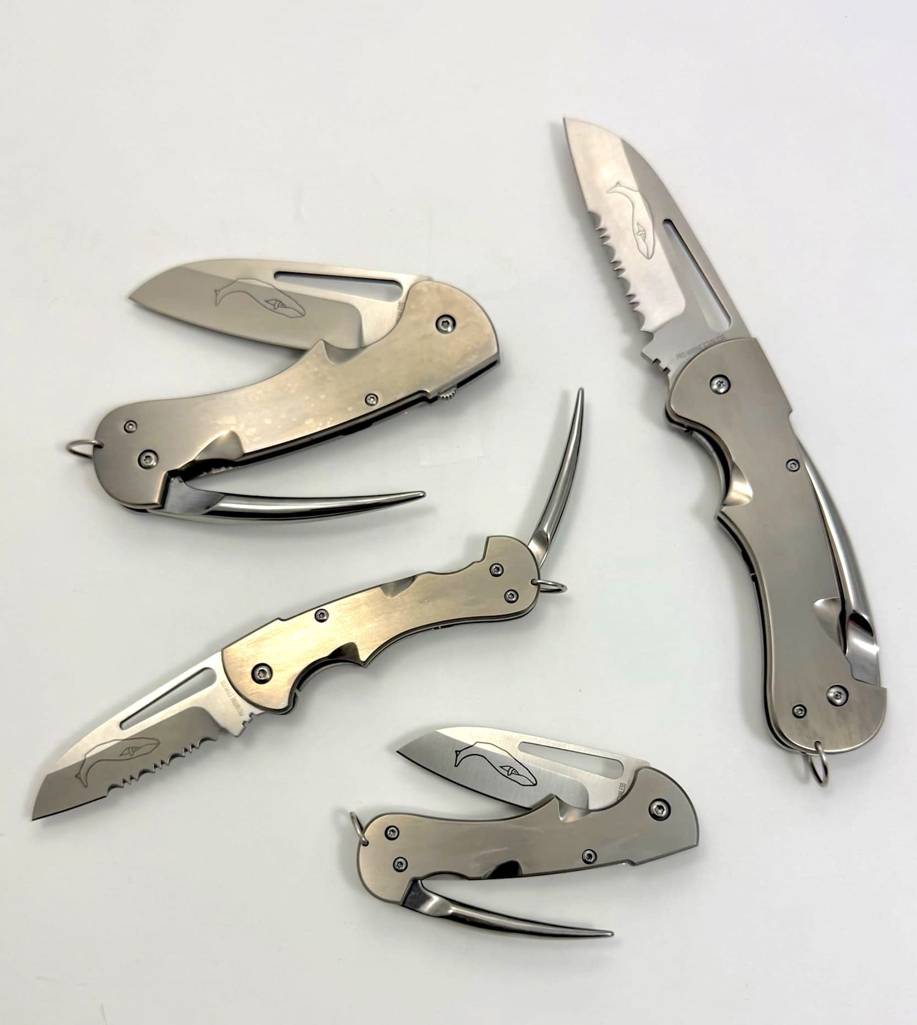 Set of four sleek folding knives displayed.