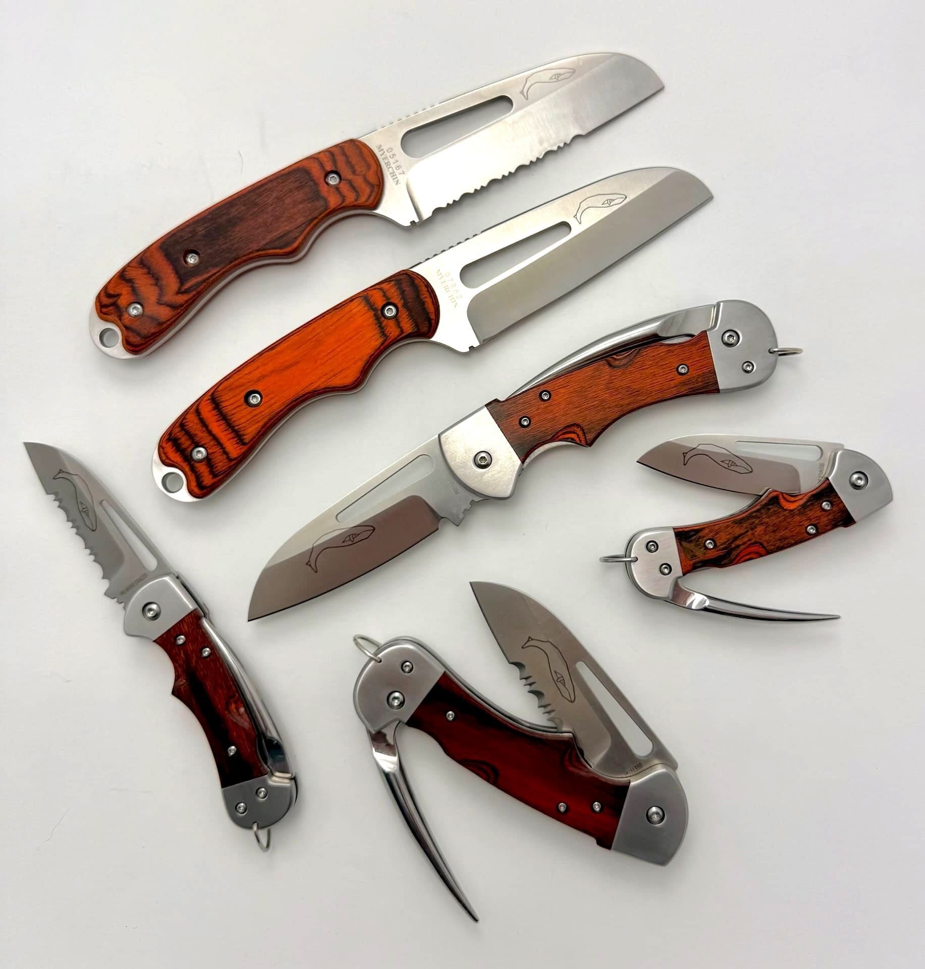 Assorted folding knives with wooden handles displayed.